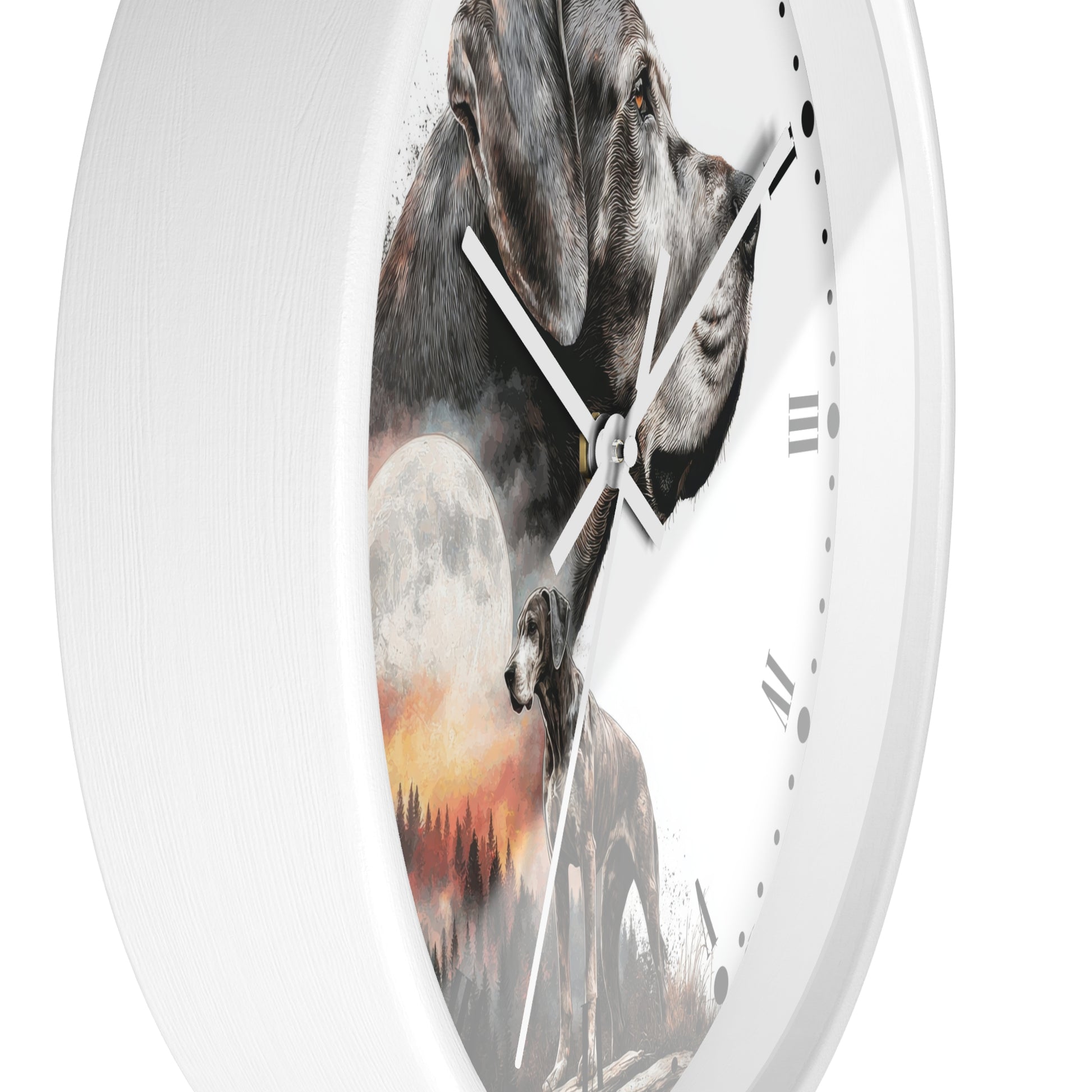 A white round wall clock with a printed design featuring a gray dog, a full moon, and a wolf silhouette over a sunset landscape.