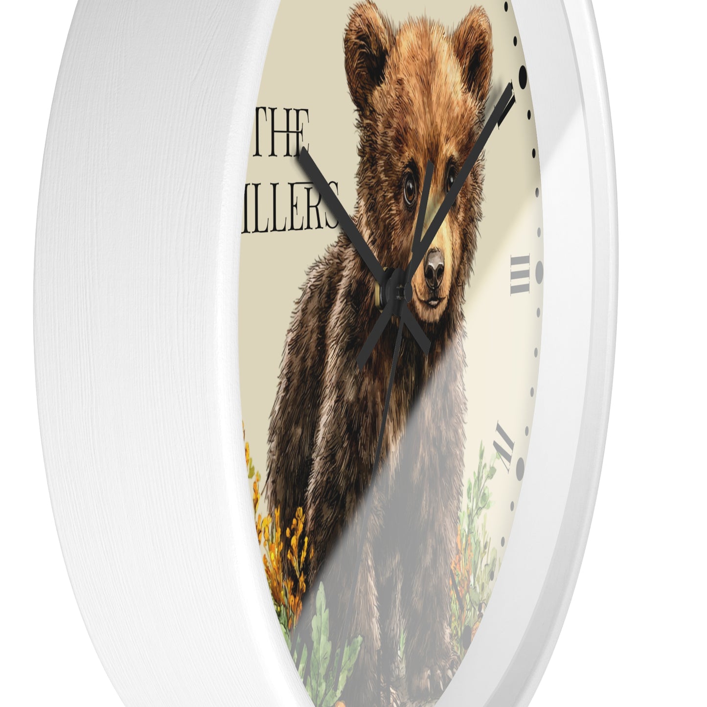 A round wall clock with a white frame and a printed face featuring a brown bear illustration, black clock hands, and the words 'THE MILLER' on a light beige background.