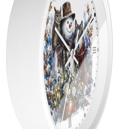 A round white wall clock featuring a winter illustration of a snowman wearing a brown hat and plaid scarf, surrounded by snowy trees , an owl, and wolf, with white clock hands and hour markers.