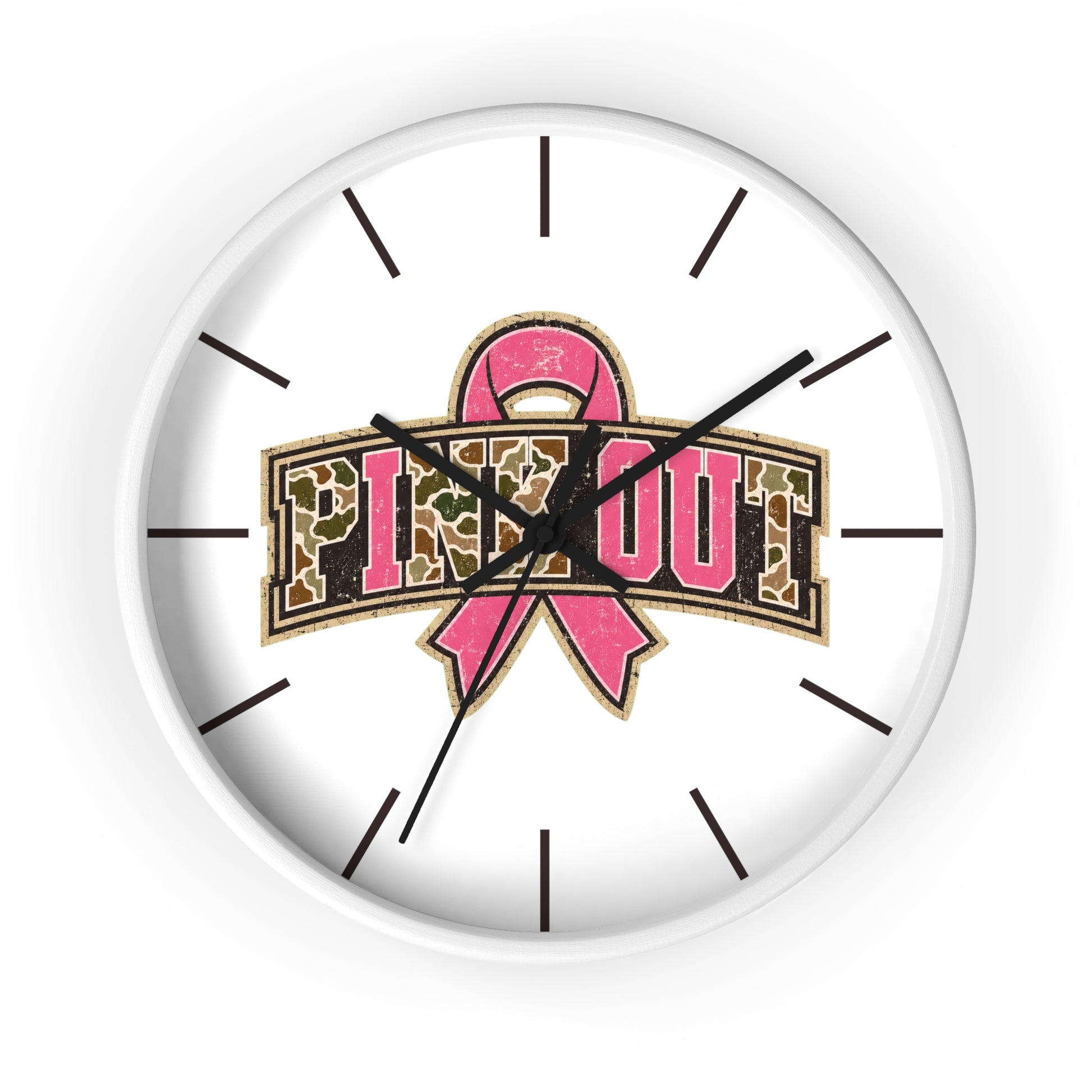 A round white wall clock with black hour markers and hands, featuring a pink breast cancer ribbon and the words 'PINK OUT' in leopard-print lettering on the face.
