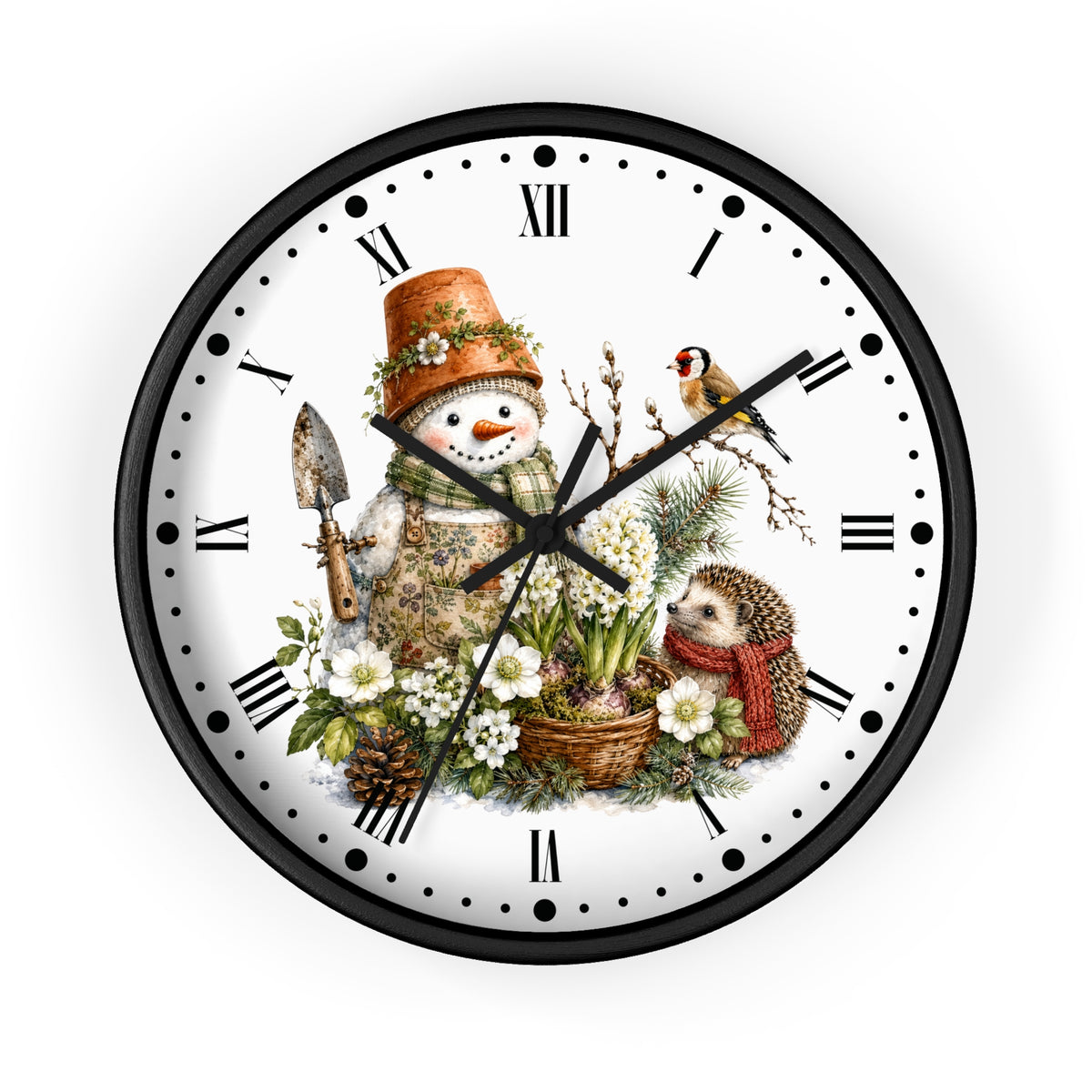 A round wall clock with a black frame and a white face featuring a whimsical winter garden illustration. The design includes a snowman wearing a terracotta pot hat and holding a trowel, a small bird perched on a branch, a hedgehog in a red scarf, white flowers, pinecones, and green foliage.