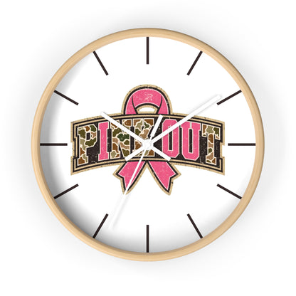 A round white wall clock with a pink breast cancer awareness ribbon and the words 'PINK OUT' in leopard-print lettering, shown against a plain white background.