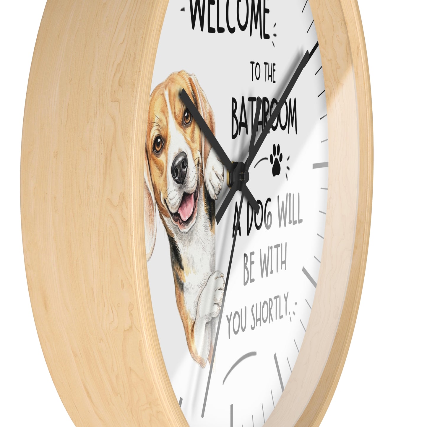 A round wall clock with a light natural wood frame and a white face featuring a beagle illustration and the text 'WELCOME TO THE BATROOM A DOG WILL BE WITH YOU SHORTLY'.