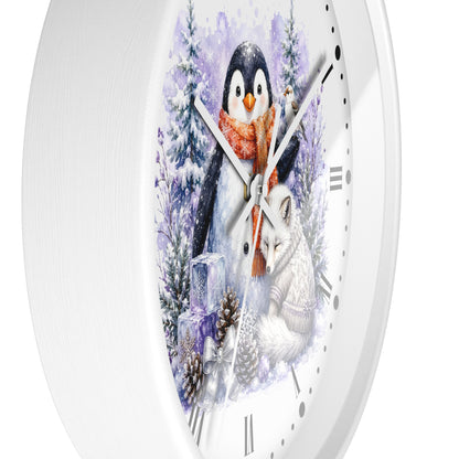 A white round wall clock with a winter-themed illustration on the face, featuring a penguin in a red scarf, a white fox, snowy trees, and pinecones.