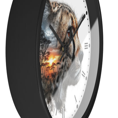 A close-up of a round wall clock with a black frame and a white face, featuring a photographic tiger face overlaid with a sunset landscape scene. The clock hands and Roman numeral markers are black.