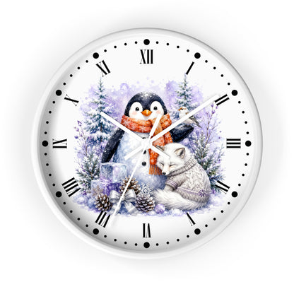A round white wall clock with black Roman numerals and markers, featuring a winter illustration of a penguin in an orange scarf and a white fox in a knit sweater among snowy trees and pinecones.