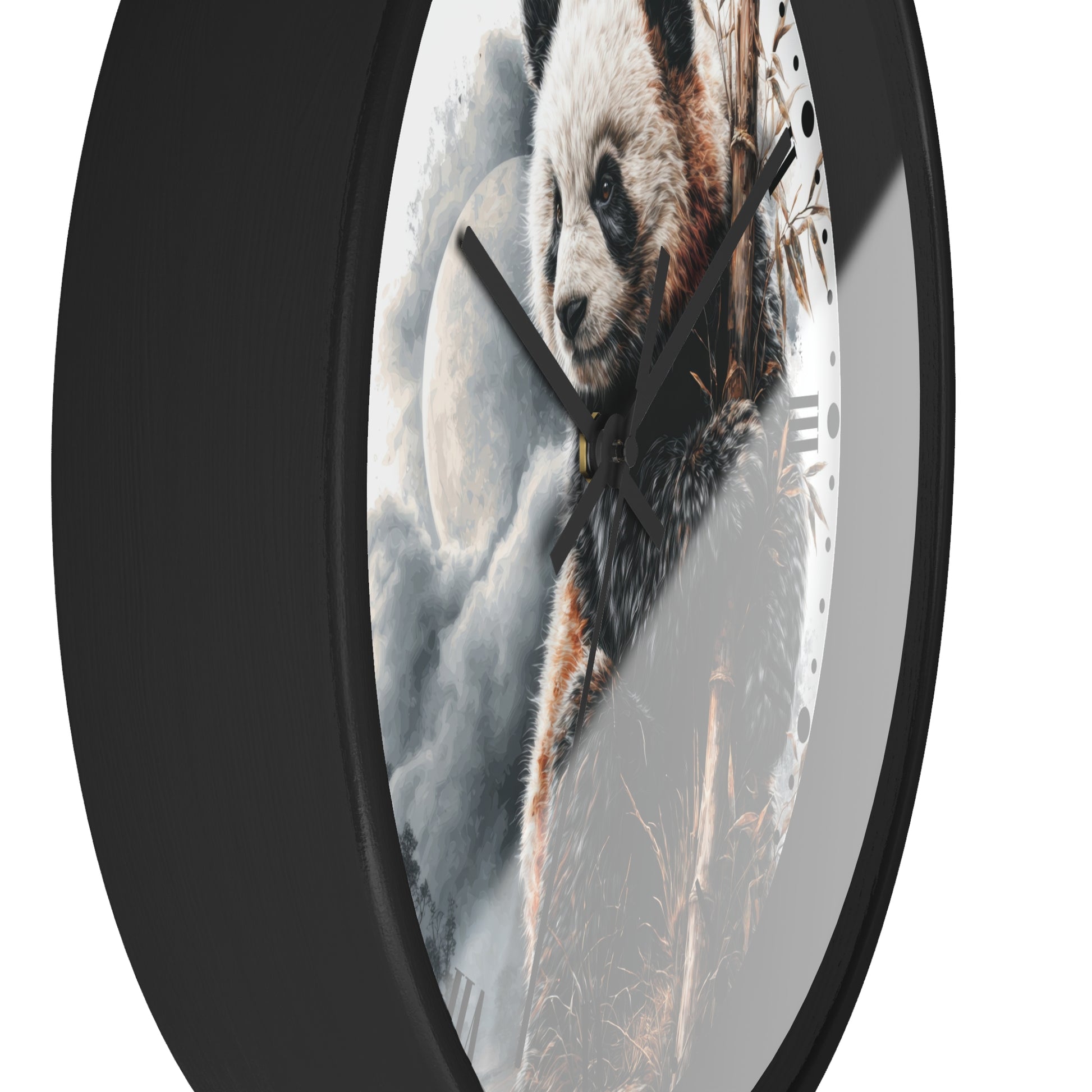 A round wall clock with a black frame and a printed panda face and bamboo scene on the clock face, shown against a plain white background.