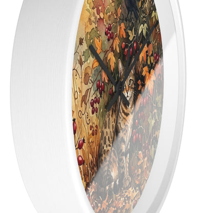 Round wall clock with a white frame and a printed autumn scene featuring a cat among leaves and red berries, shown against a plain white background.