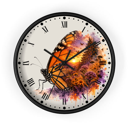 Round wall clock with a black frame and a white face featuring a large orange-and-black butterfly over a colorful floral and sunset illustration. Black Roman numerals and clock hands are visible.