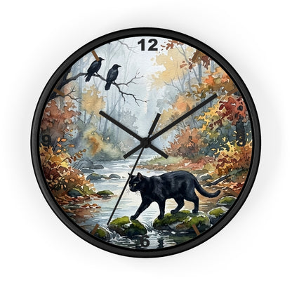 Round wall clock with a black frame and a printed autumn forest scene on the face, featuring a black cat by a stream, two crows on branches, and the number 12 at the top.
