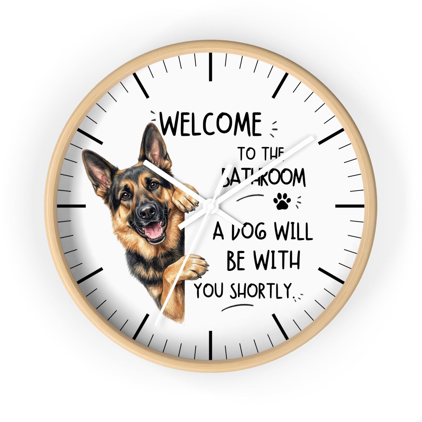 A round wall clock with a light wood frame and a white face, featuring a German Shepherd illustration and the text 'WELCOME TO THE BATHROOM A DOG WILL BE WITH YOU SHORTLY.' on a plain white background.