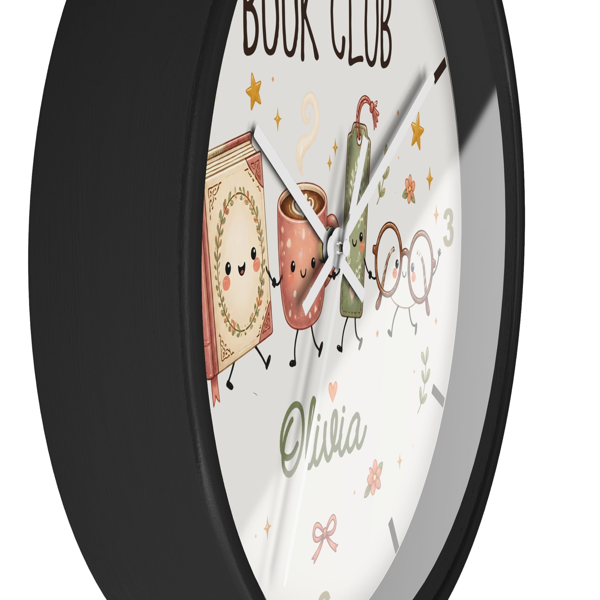 A round wall clock with a black frame and a white face featuring a cute book-and-coffee-club illustration, gold stars, the words 'BOOK CLUB' at the top, and the name 'Olivia' near the bottom.
