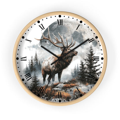 Round wall clock with a light wood frame and a printed scenic dial showing a large deer standing in a misty forest under a full moon, with black Roman numerals and black clock hands.