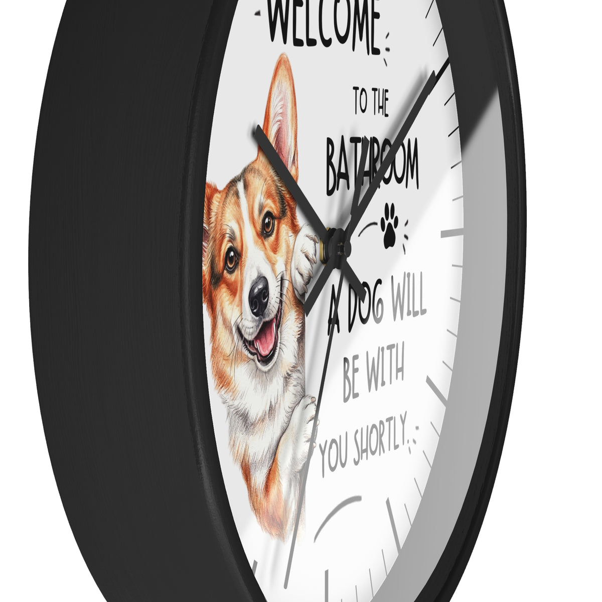 A round wall clock with a black frame and a white face, featuring a cartoon corgi illustration and the text 'WELCOME TO THE BATROOM A DOG WILL BE WITH YOU SHORTLY'.