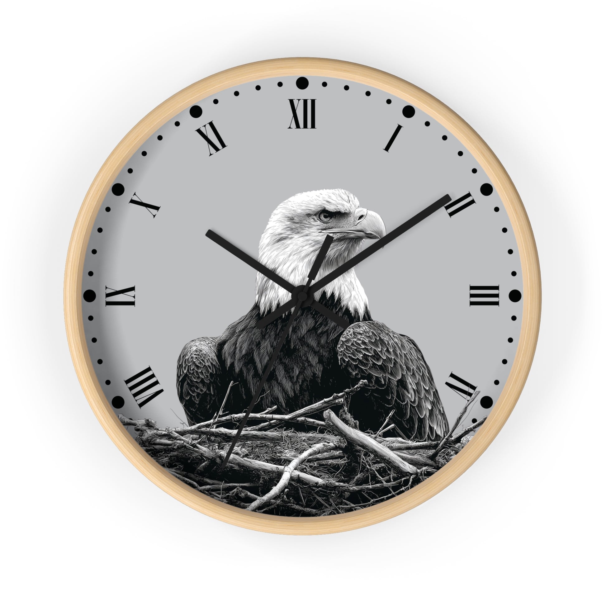 Round wall clock with a light wood frame, black Roman numerals, and a grayscale photograph of a bald eagle sitting in a nest on the clock face, shown against a plain white background.