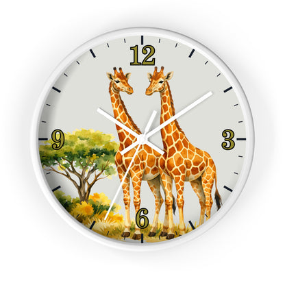 A round wall clock with a white frame and a safari-themed dial featuring two giraffes, a tree, and gold Arabic numerals on a light gray background.