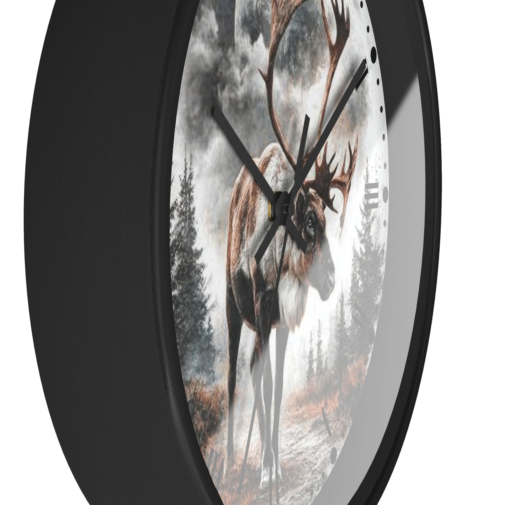 A round wall clock with a black frame and a printed scenic face showing a large deer in a misty forest. The clock is photographed against a plain white background.
