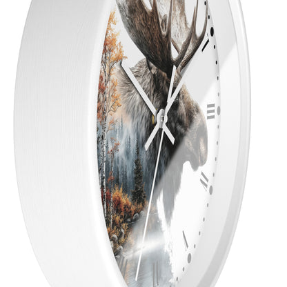 A white round wall clock with a split design: one half shows a moose head and the other half shows a forest scene, with white hands and black Roman numerals.