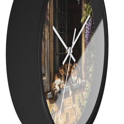 A round wall clock with a black frame and a printed scenic design featuring a calico cat by a window, white clock hands, and a clear glass face.