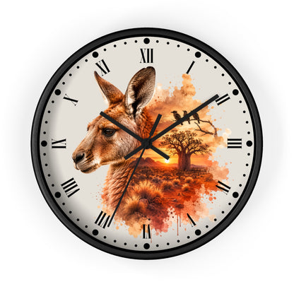 A round wall clock with a black frame and a printed face featuring a kangaroo head, a tree, birds, and an orange sunset scene. The clock has black Roman numerals and black hands on a white background.