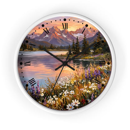 A round wall clock with a white frame and a scenic landscape print featuring mountains, a lake, trees, and wildflowers. The clock face has black Roman numerals and black hands.