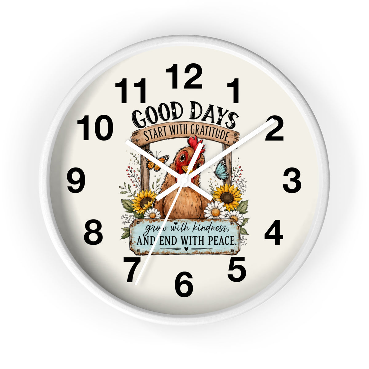 A round wall clock with a white frame and an off-white face, featuring a central illustration of a brown chicken surrounded by sunflowers and a butterfly. The clock face includes the text 'GOOD DAYS START WITH GRATITUDE' and 'grow with kindness AND END WITH PEACE' along with black numerals from 1 to 12.