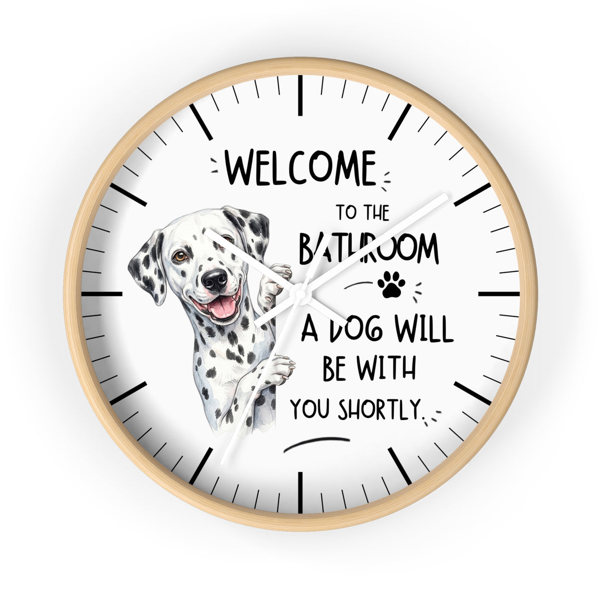 A round wall clock with a light wood frame and a white face, featuring a watercolor illustration of a Dalmatian dog and the text 'WELCOME TO THE BATHROOM A DOG WILL BE WITH YOU SHORTLY.' on a plain white background.