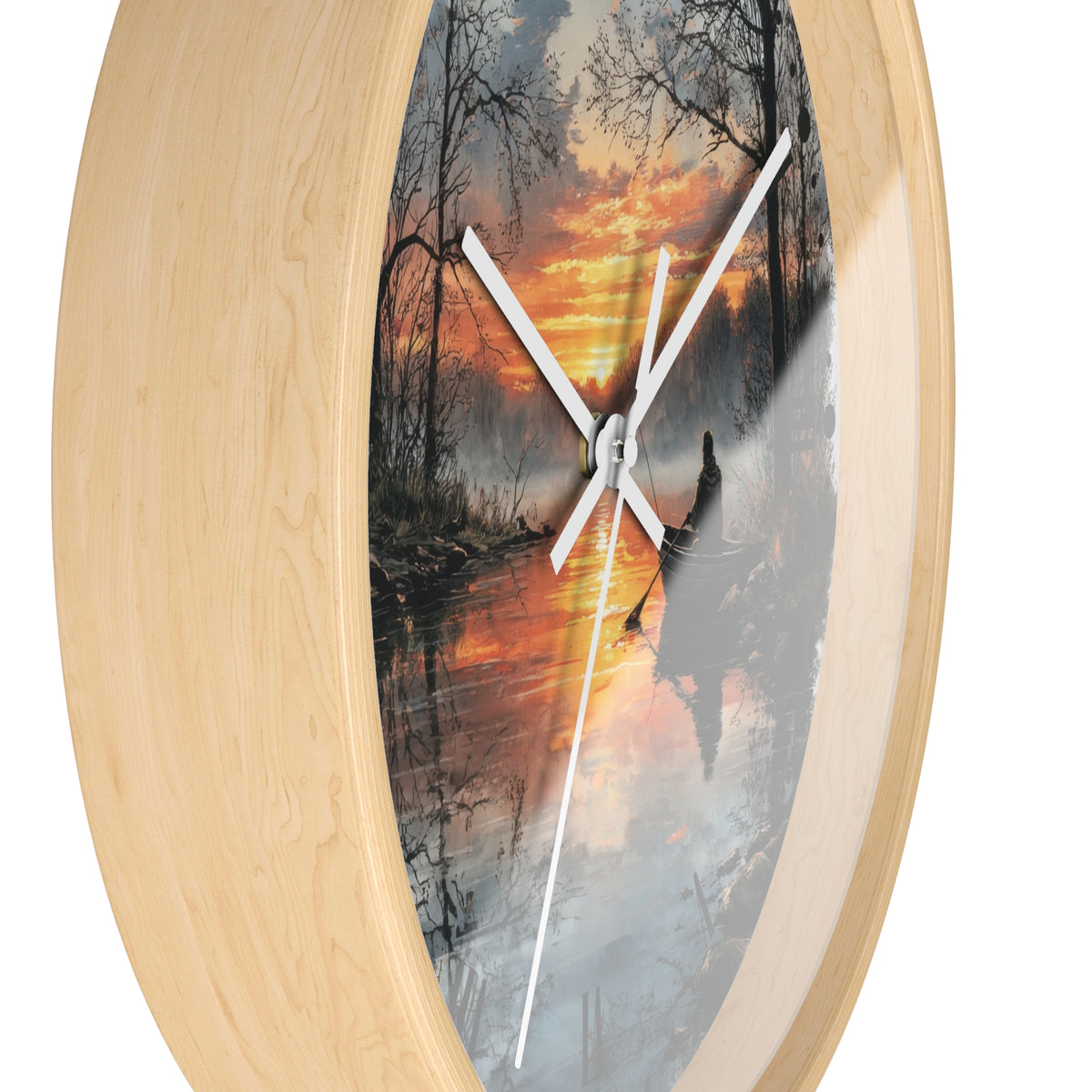 Oval wall clock with a light natural wood frame and a printed scenic dial showing a forest lake sunset with white clock hands.