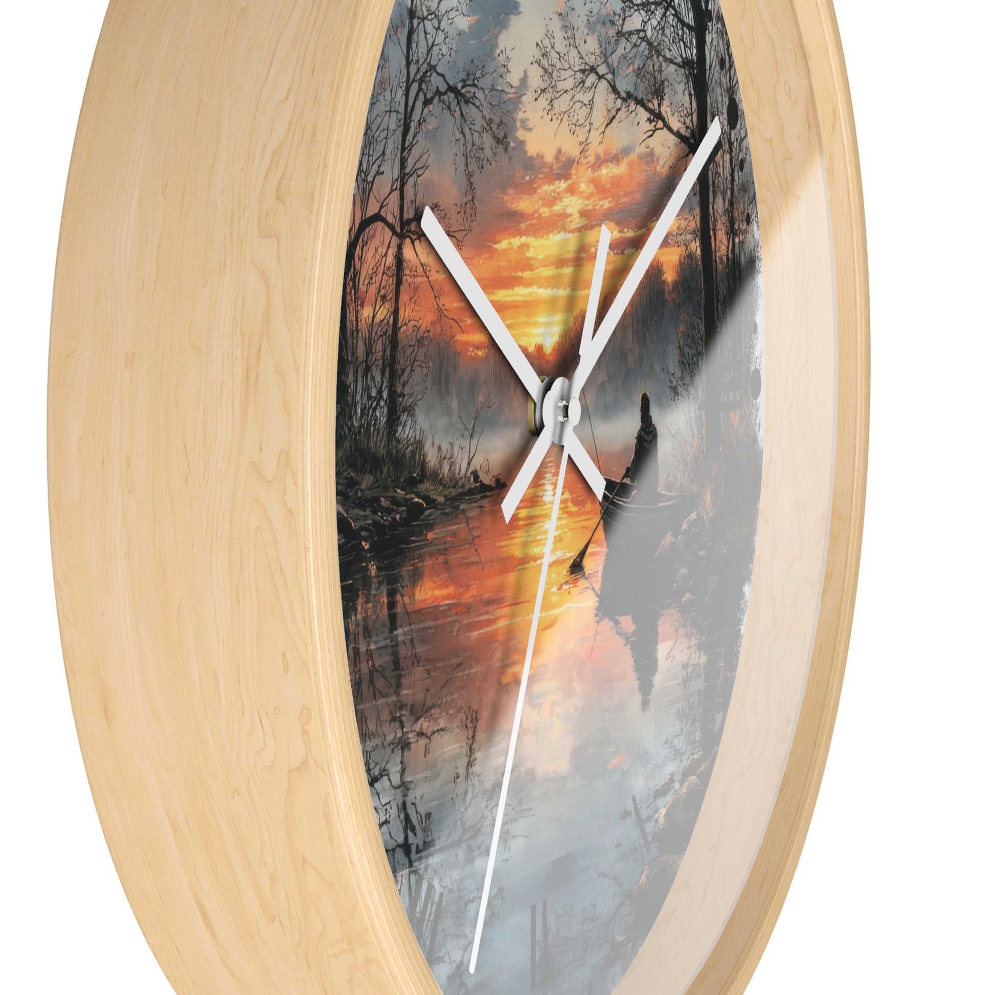 Oval wall clock with a light natural wood frame and a printed scenic dial showing a forest lake sunset with white clock hands.