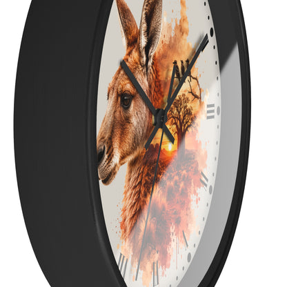A round wall clock with a black frame and a white dial featuring a painted kangaroo portrait blended with autumn tree leaves and a warm orange sunset.