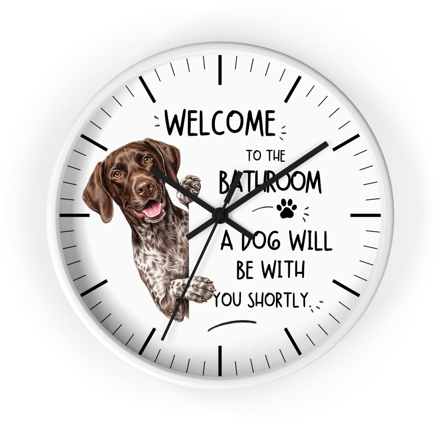 A round white wall clock with black hands and hour markers, featuring a brown and white pointer dog illustration and the text 'WELCOME TO THE BATHROOM A DOG WILL BE WITH YOU SHORTLY.' on a white background.