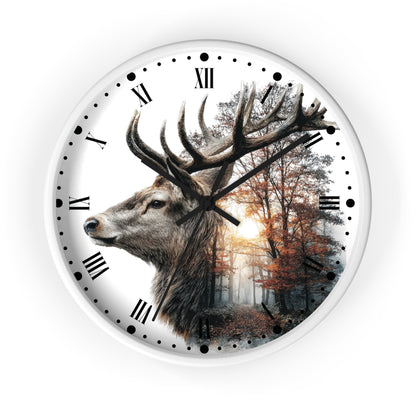 A round wall clock with a white frame and a printed design featuring a large deer head on the left side and a forest scene on the right, with black Roman numerals and hands on a white background.