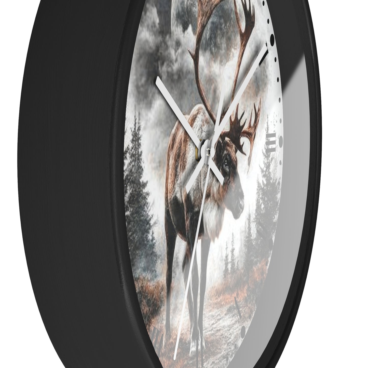 A round wall clock with a black frame and a printed nature scene featuring a large deer in a misty forest. The clock is shown at an angle against a plain white background.
