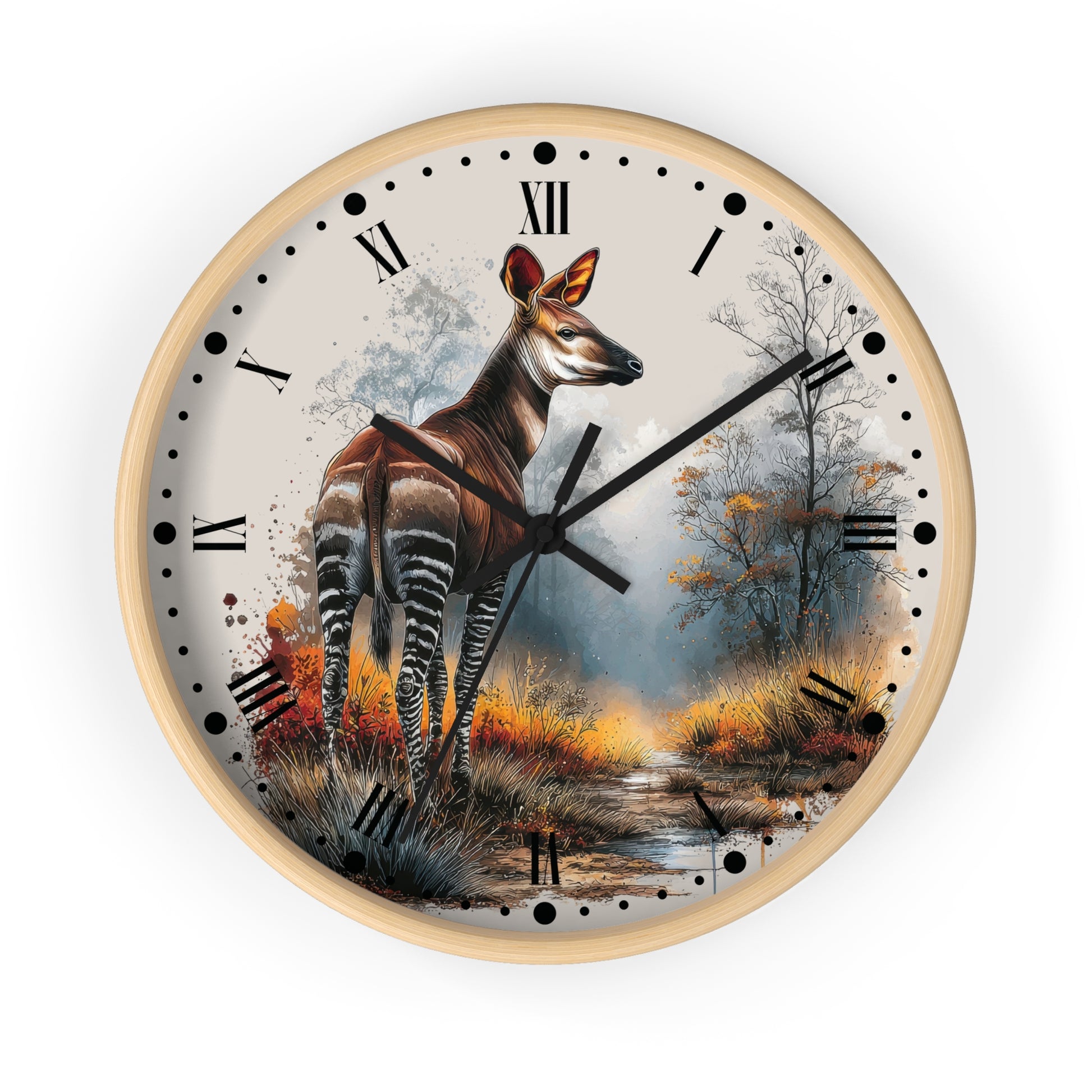A round wall clock with a light wood frame and a printed nature scene on the face. The artwork shows a Okapi antelope standing in a misty woodland with trees and autumn foliage.
