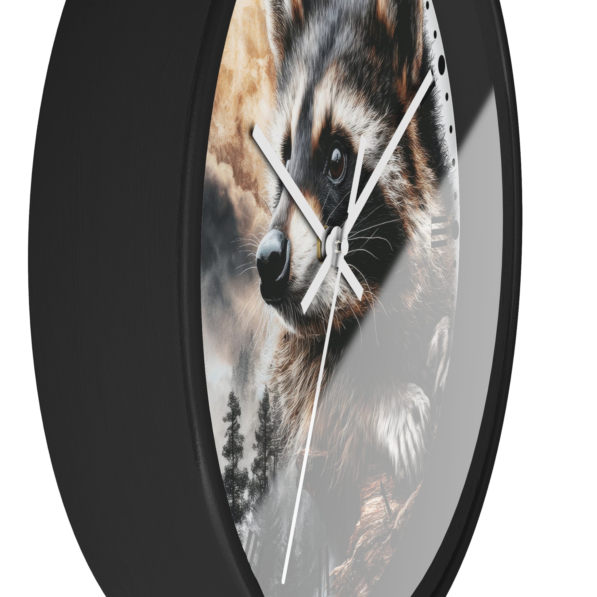 A round wall clock with a black frame and white hands, featuring a printed raccoon face and forest scene on the face. The clock is shown against a plain white background.