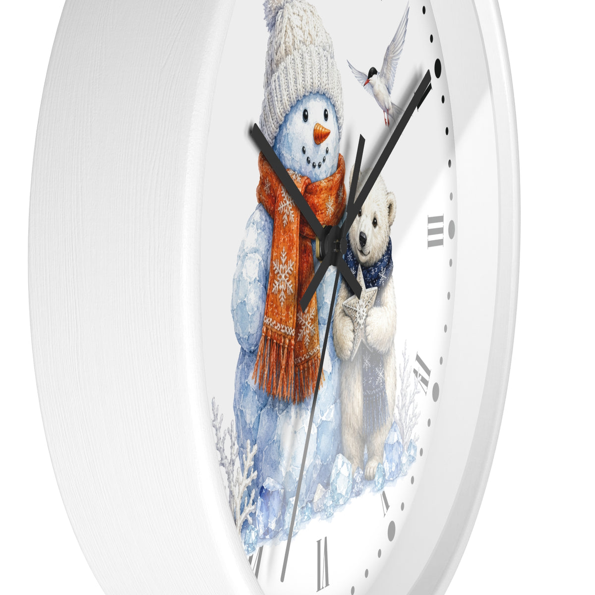 A white round wall clock with a winter illustration on the face, showing a snowman in a white knit hat and orange scarf next to a polar bear, with black hands and black Roman numerals.