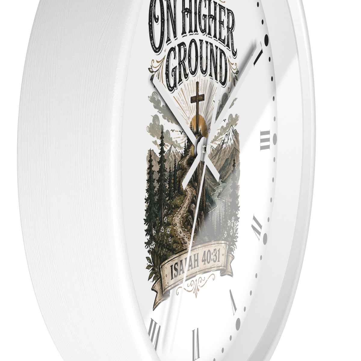 A white round wall clock with a printed scenic graphic on the face. The design features the text 'ON HIGHER GROUND' at the top and 'ISRAEL 40:31' on a banner at the bottom, surrounding an illustration of a mountain pass through pine trees with a cross and sun.