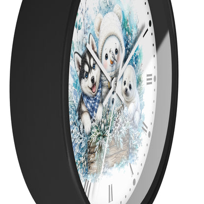 A round wall clock with a black frame and a white face featuring a winter illustration of a husky, a snowman, and a puppy in blue and white tones.