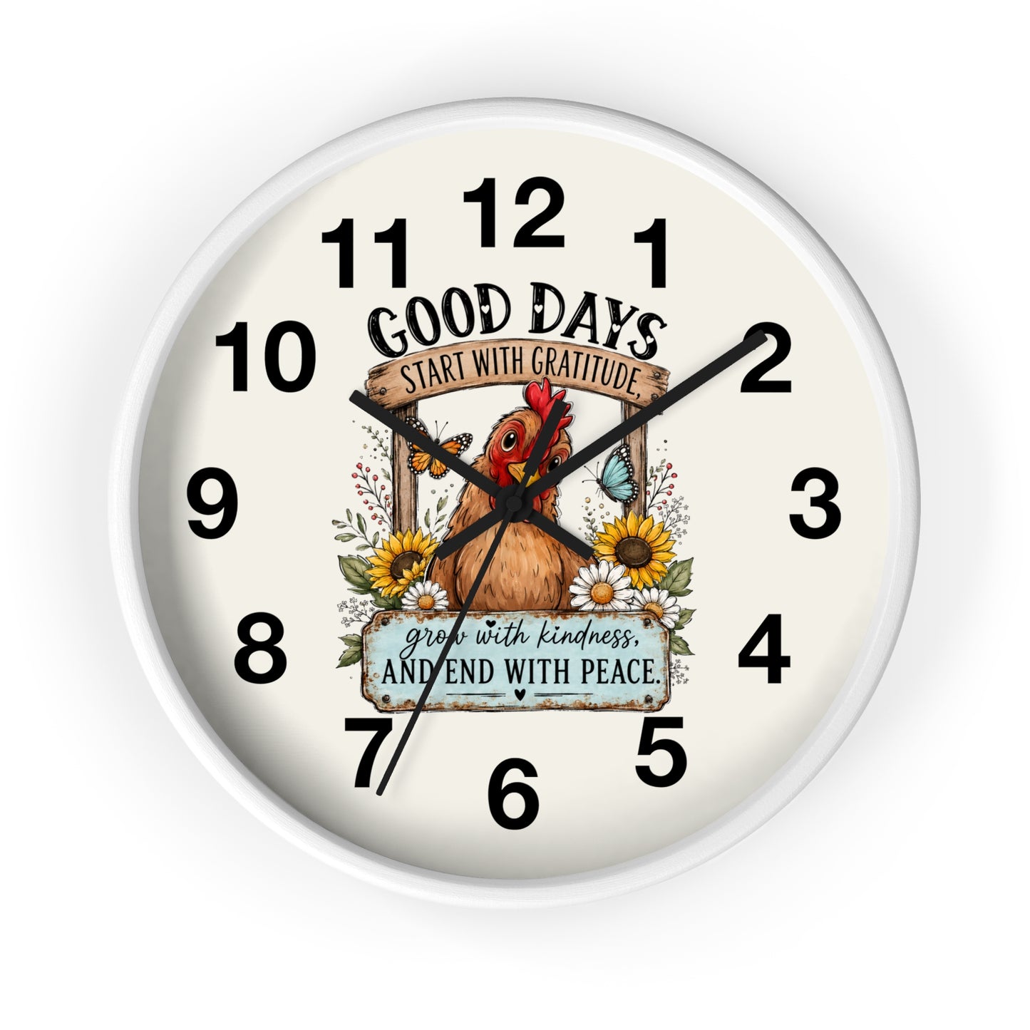 A round wall clock with a white frame and an off-white dial featuring a central illustration of a brown chicken surrounded by sunflowers and butterflies. The text on the dial reads 'GOOD DAYS START WITH GRATITUDE' and 'grow with kindness AND END WITH PEACE.