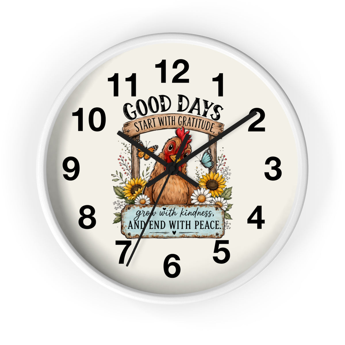 A round wall clock with a white frame and an off-white dial featuring a central illustration of a brown chicken surrounded by sunflowers and butterflies. The text on the dial reads 'GOOD DAYS START WITH GRATITUDE' and 'grow with kindness AND END WITH PEACE.