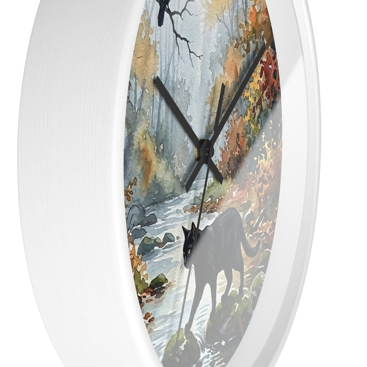 A round wall clock with a white frame and a printed nature scene on the face, showing a forest stream, autumn foliage, and a black cat silhouette. The clock is photographed against a clean white background.