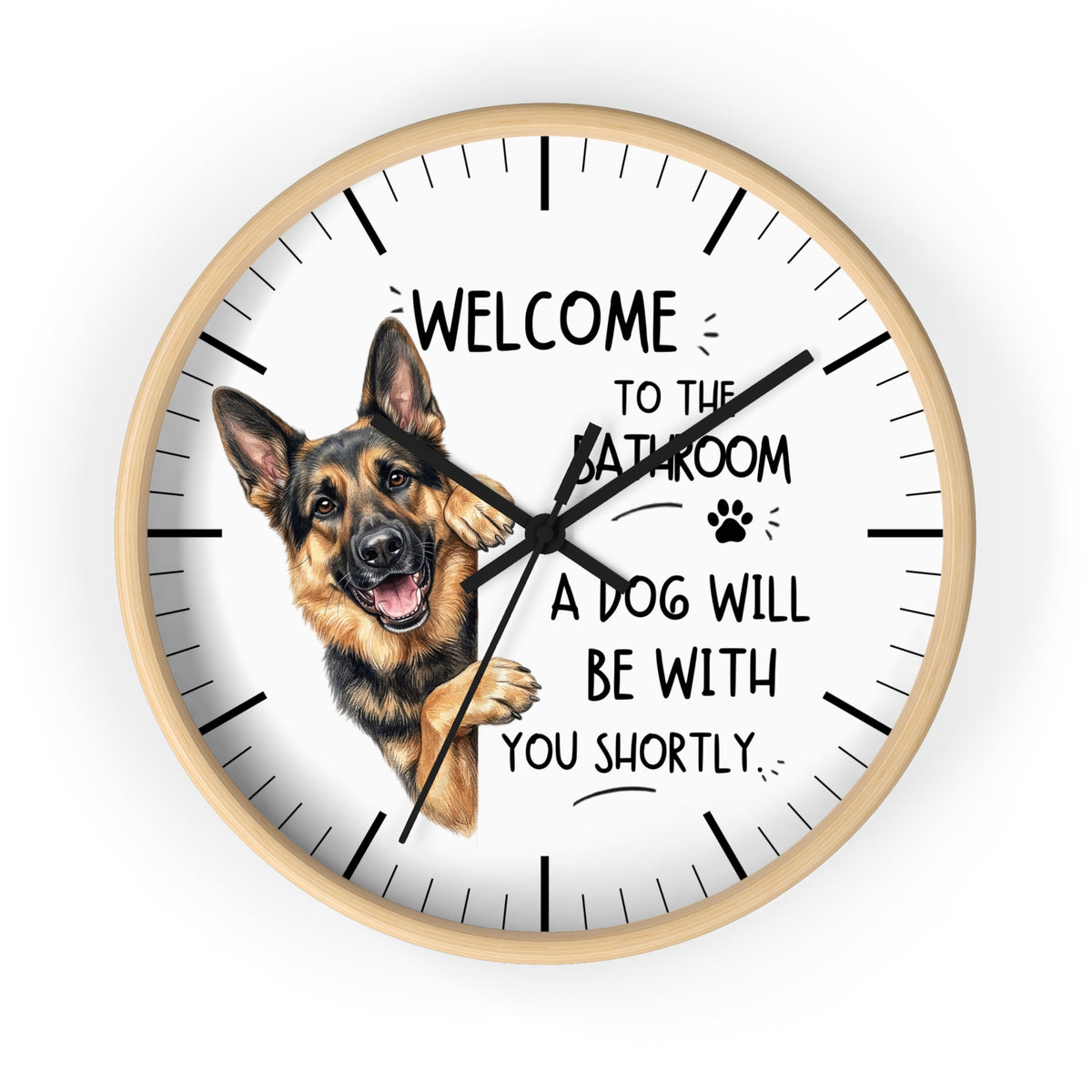 A round wall clock with a light wood frame and a white face, featuring a German Shepherd illustration and the text 'WELCOME TO THE BATHROOM A DOG WILL BE WITH YOU SHORTLY.' on a plain white background.
