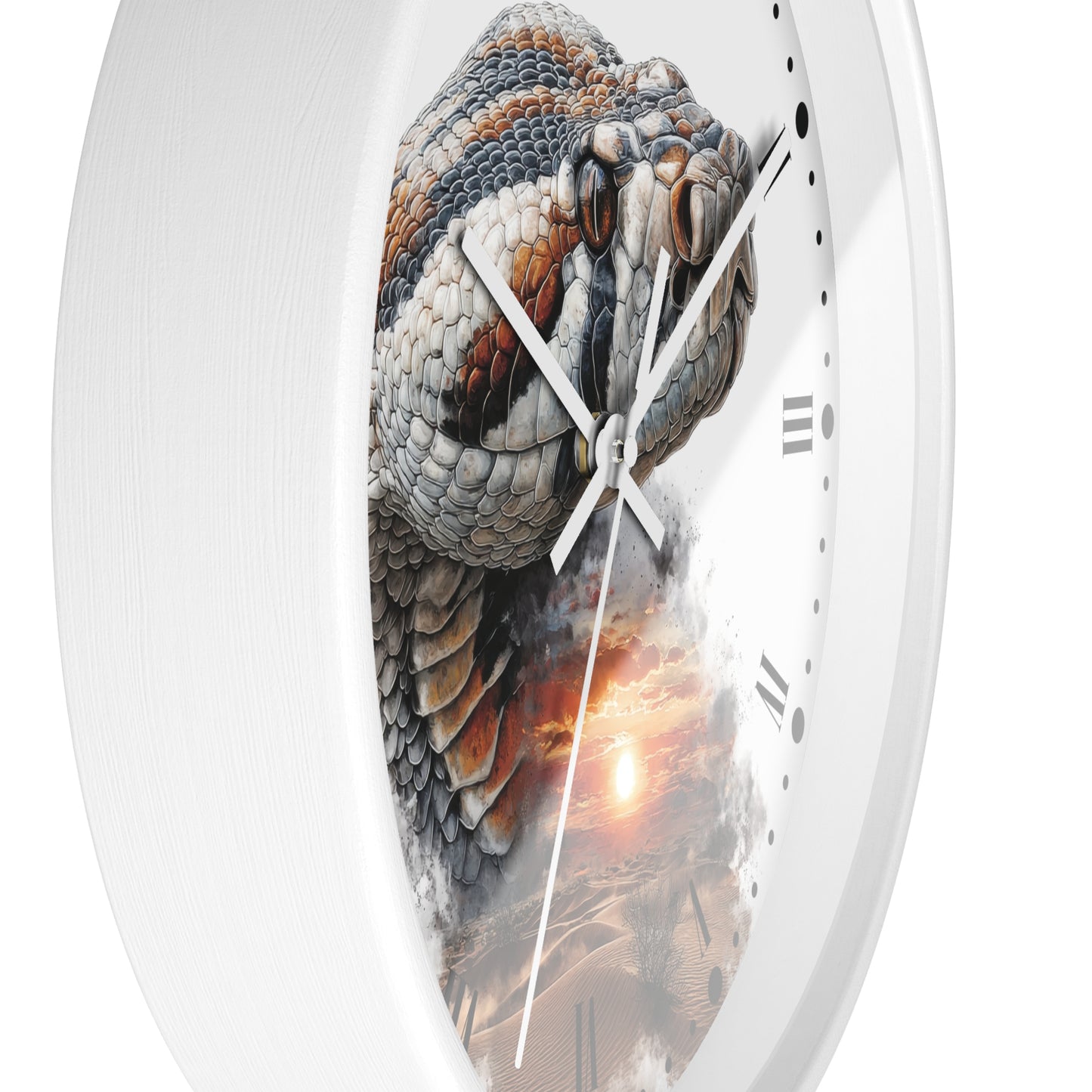 A close-up of a round wall clock with a white frame and a printed snake design wrapping around the face. The clock shows Roman numerals on the right side and has white hands over a desert sunset scene near the bottom.