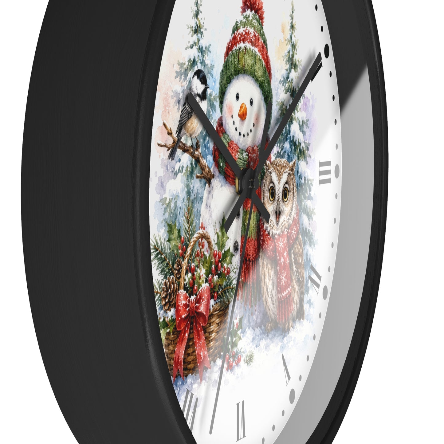 A round wall clock with a black frame and a white face featuring a festive winter illustration of a snowman, owl, bird, and holiday wreath.