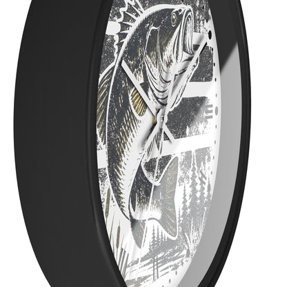 A close-up of a round wall clock with a black frame and a white dial featuring a detailed black-and-white fish illustration with subtle gold accents.