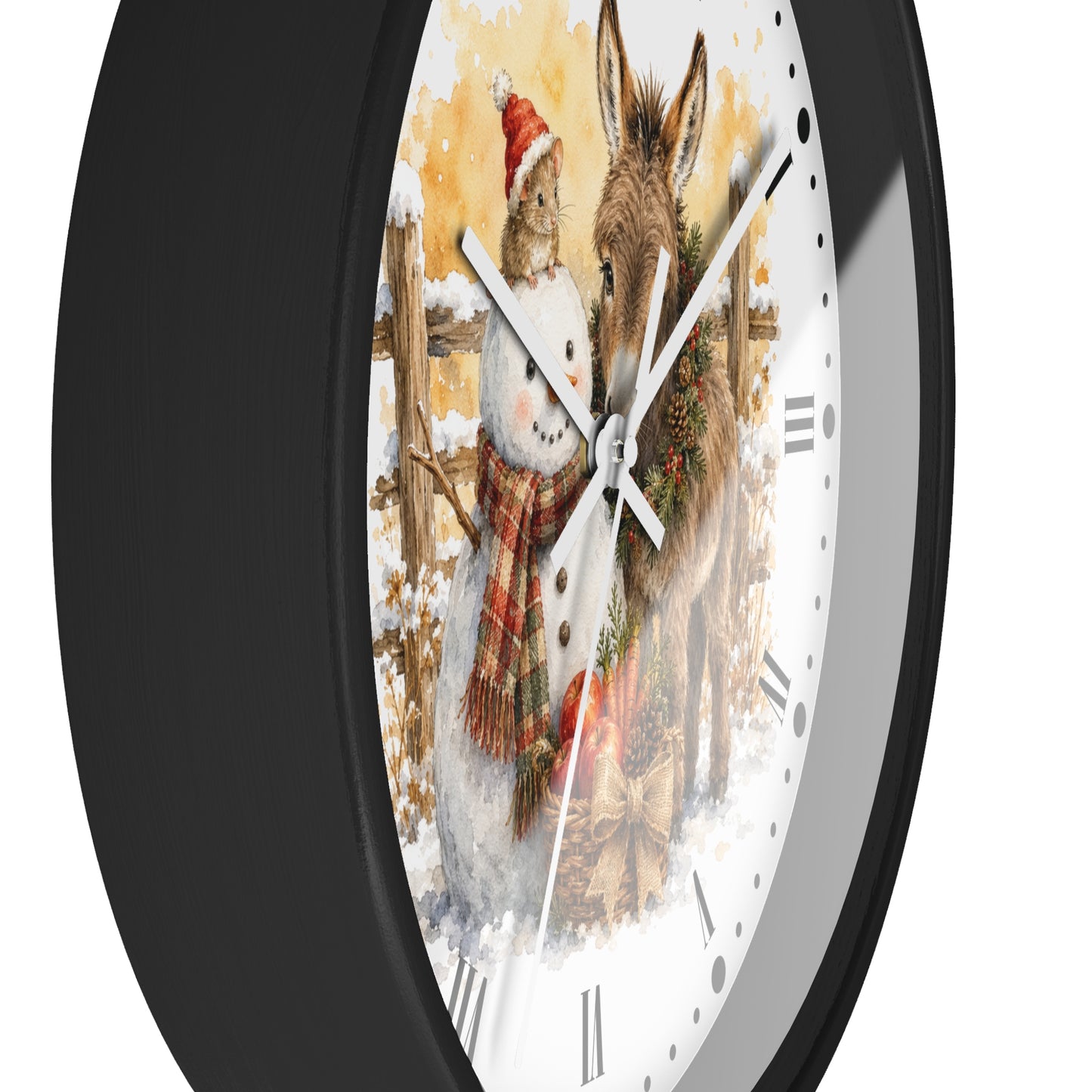 A round wall clock with a black frame and a white face featuring a winter illustration of a snowman and a donkey, shown against a plain white background.