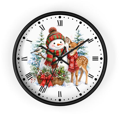 A round wall clock with a black frame and a white face featuring a festive Christmas illustration of a snowman, a deer, evergreen trees, and red ornaments.