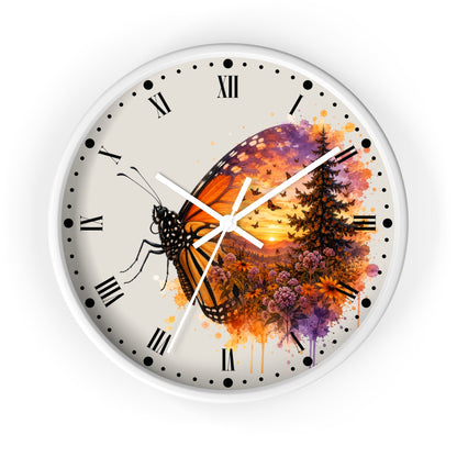 A round wall clock with a white frame and a cream-colored face, featuring a watercolor-style design of a monarch butterfly over a sunset landscape with trees and flowers. The clock has black Roman numerals and white hands.