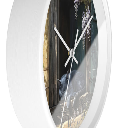 Round white wall clock with a printed scenic face showing a gray cat at a wooden door and wisteria flowers, photographed against a white background.