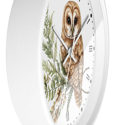 A white round wall clock with a detailed illustration of a brown barn owl perched among green leaves and branches on the clock face, with black Roman numerals and silver hands.